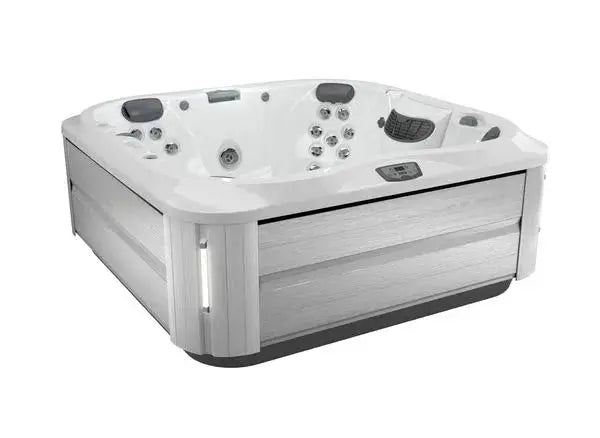 A white, square J-335 COMFORT HOT TUB WITH OPEN SEATING with gray wood paneling on the sides is shown. Featuring Jacuzzi® PowerPro® jet technology and a digital control panel, the spacious interior has multiple jet nozzles and headrests, designed to accommodate several people comfortably.