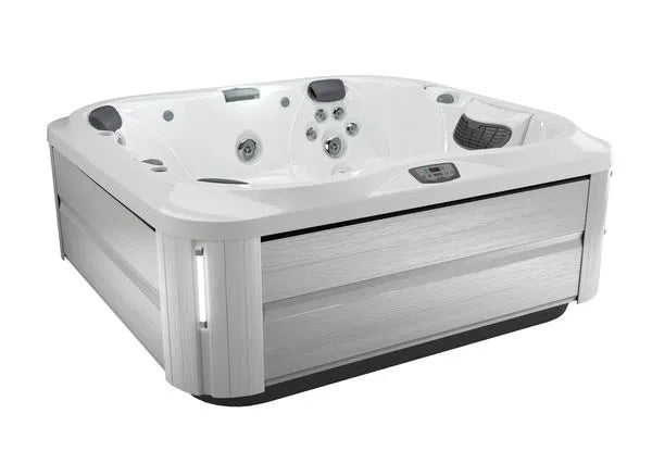 A modern, square Jacuzzi J-355 HOT TUB WITH COMFORT LOUNGE SEATING & COOL DOWN SEAT with a white interior and light gray exterior panels. It is equipped with multiple hydrotherapy jets, ergonomic seating, and a small digital control panel on the side. Featuring the ProClear filtration system, the hot tub appears clean and new, ready for use.