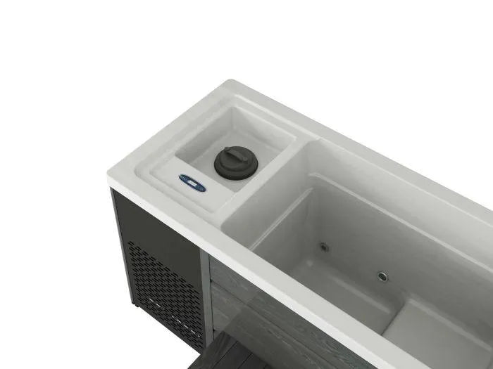 A partial top view of a Chillax Ice Bath & Chill Tub Professional affordable wellness Ice Baths & Plunge Pool by Chill Tubs, showing a section with a built-in control panel and circular knob. The tub features a textured exterior and smooth interior. The image focuses on the corner, capturing some side vents and the tub's edge detail, perfect for alternating with cold water immersion for inflammation reduction.