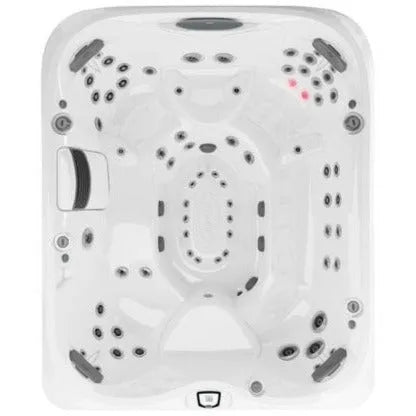 An overhead view of a white rectangular Jacuzzi J-495™ DESIGNER ENTERTAINER'S HOT TUB WITH INFRARED & RED LIGHT THERAPY - NEW MODEL with multiple jet nozzles and control buttons. The tub boasts several seating positions, complete with armrests and headrests designed for comfort, delivering an unparalleled hydromassage experience with its advanced PowerPro jets.