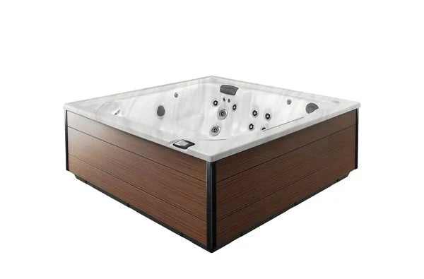 A square Jacuzzi - J-LXL Hot Tub with a sleek, modern design. It features a white, contoured interior with multiple jets and control panels for hydrotherapy. The exterior has a wood-like finish with black detailing at the corners. The hot tub is empty and sits against a plain white background.