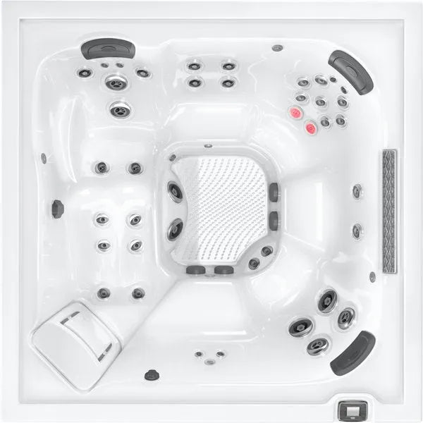 A top-down view of a Jacuzzi - J-LXL Hot Tub with multiple built-in jets and seating areas. The interior is white, with various water jets of different sizes positioned throughout. This hydrotherapy hot tub features headrests, control panels, and red indicator lights near one of the seats.