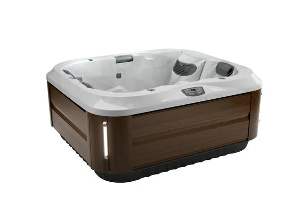 A medium-sized, square hot tub with a white interior and wooden exterior. The J-315 COMFORT HOT TUB WITH LOUNGER FOR SMALL SPACES by Jacuzzi features multiple seats, including lounge-style seating, and has an integrated control panel on one of the interior edges. Experience the hydrotherapy benefits enhanced by the powerful PowerPro® jets.