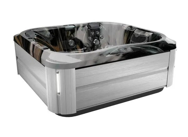 A modern, square Jacuzzi J-355 HOT TUB WITH COMFORT LOUNGE SEATING & COOL DOWN SEAT with sleek, silver paneling on the sides and a darker, marbled interior. It features multiple hydrotherapy jets and a built-in control panel, designed for outdoor or indoor use.