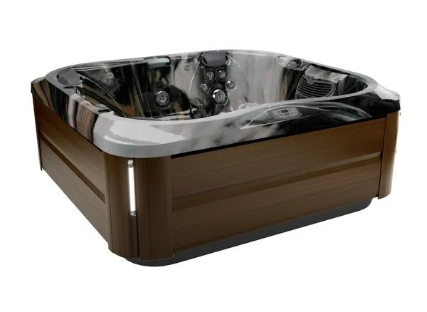 A modern **Jacuzzi J-355 HOT TUB WITH COMFORT LOUNGE SEATING & COOL DOWN SEAT** with a sleek, dark wood exterior finish and a glossy, reflective grey and black interior. The hot tub is equipped with multiple hydrotherapy jets and controls, designed to accommodate several people for a relaxing water massage experience.