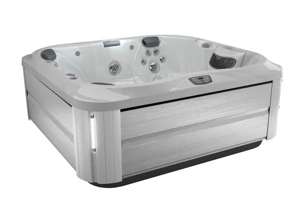 A modern, square Jacuzzi J-355 HOT TUB WITH COMFORT LOUNGE SEATING & COOL DOWN SEAT with a white interior and sleek, light gray exterior panels. The hot tub features several hydrotherapy jets, padded headrests, and digital controls on the inside edge. It stands alone against a plain white background.