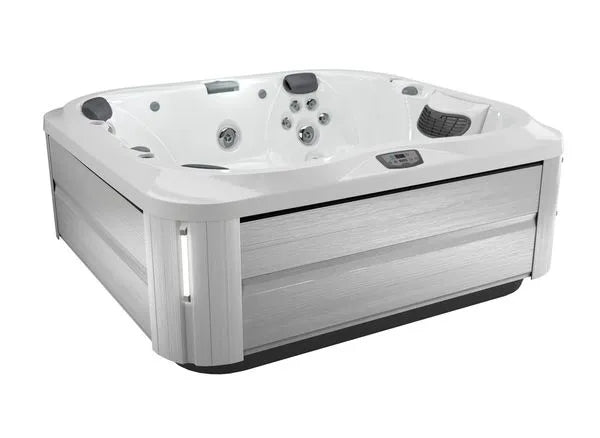 A modern, square Jacuzzi J-355 HOT TUB WITH COMFORT LOUNGE SEATING & COOL DOWN SEAT with a white interior and light gray exterior panels. It is equipped with multiple hydrotherapy jets, ergonomic seating, and a small digital control panel on the side. Featuring the ProClear filtration system, the hot tub appears clean and new, ready for use.
