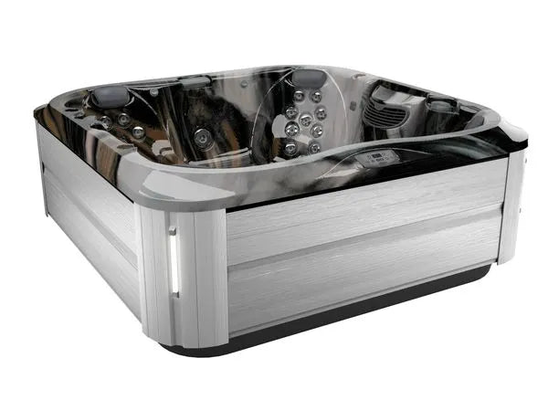 A luxury J-375 COMFORT HOT TUB WITH LARGEST LOUNGE SEAT NEW by Jacuzzi with a sleek design featuring stainless steel exterior panels and a black, glossy interior. It boasts multiple jet configurations, built-in headrests, and control buttons on the interior side panel. The advanced hydromassage technology makes it spacious, comfortable for indoor and outdoor installation.