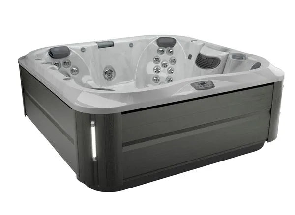 A modern, rectangular J-375 COMFORT HOT TUB WITH LARGEST LOUNGE SEAT NEW by Jacuzzi with dark wood paneling on the exterior, a smooth white interior, advanced hydromassage technology, and ergonomic seating. It features multiple jets, a control panel on the inner edge, headrests on the seats, and is suitable for both indoor and outdoor installation.