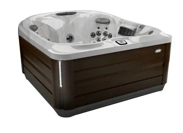 A luxurious square hot tub with wood panel siding and a white interior, featuring Jacuzzi PowerPro jets for optimal hydrotherapy. It includes a control panel, cup holders, and an ergonomically designed interior to comfortably accommodate multiple users. This is the J-445™ OPEN SEATED HOT TUB WITH INFRARED & RED LIGHT THERAPY by Jacuzzi.