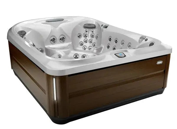 A Jacuzzi J-495™ Designer Entertainer's Hot Tub with Infrared & Red Light Therapy - New Model with a sleek, modern design featuring a white interior and wooden panel exterior. The interior has multiple built-in seats with PowerPro jets and controls for a customized hydromassage experience.