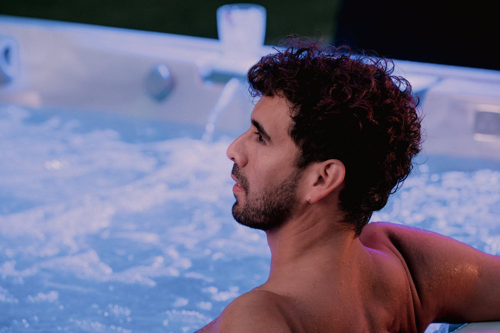 Man relaxing in a hot tub with water bubbles