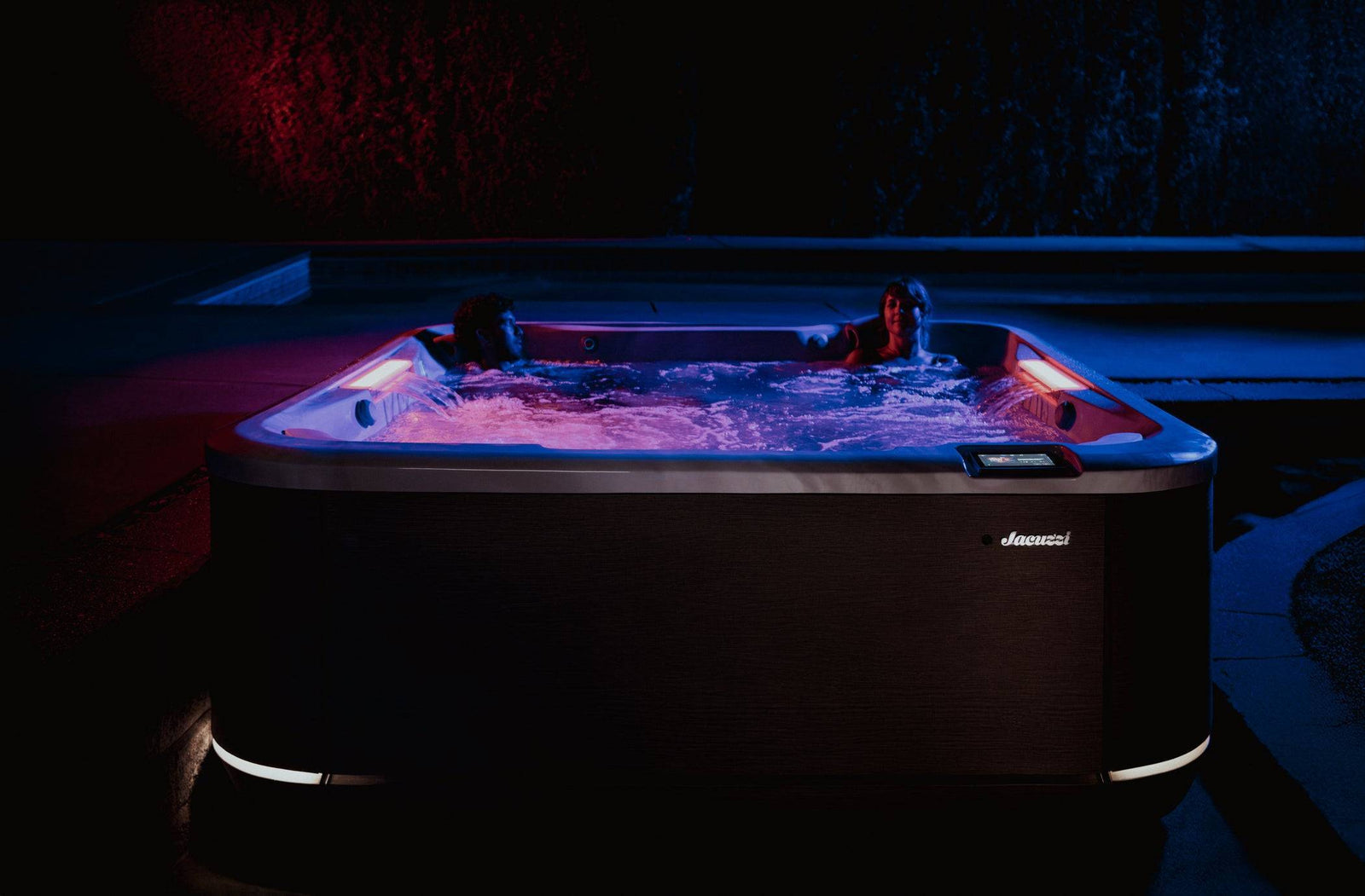 Hot tub with illuminated interior in a dark setting