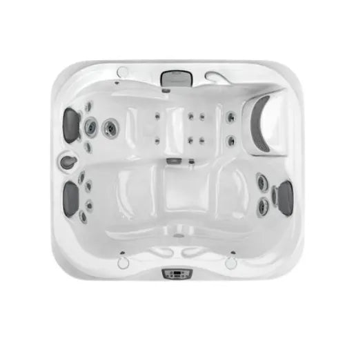 A top-down view of a white rectangular petite J-315 COMFORT HOT TUB WITH LOUNGER FOR SMALL SPACES by Jacuzzi with multiple PowerPro® jets, headrests, and a built-in control panel. The hot tub has contours shaping seating areas for several people, including a lounger seat, offering exceptional hydrotherapy benefits.