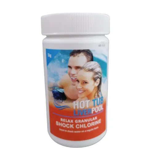 A white plastic bottle labeled &quot;Hot Tub Liverpool Shock Chlorine - 1KG&quot; with a 1 kg weight indication. The label features an image of a smiling couple in a hot tub. This essential hot tub chemical from Hot Tub Liverpool is intended for shocking water regularly to maintain crystal-clear conditions.