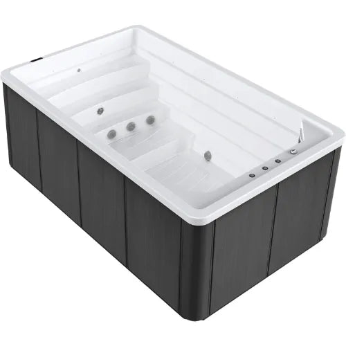 A rectangular Oasis Riptide - Atlantis Pro Premium 4.4 Swim Pool with Inverter from Oasis Spas, with a white interior and dark gray exterior panels, equipped with the advanced SPATECH TP10 touchscreen controls. The interior features multiple seating levels and hydrotherapy jets, designed for relaxation and massage, while the sleek exterior boasts a modern design.