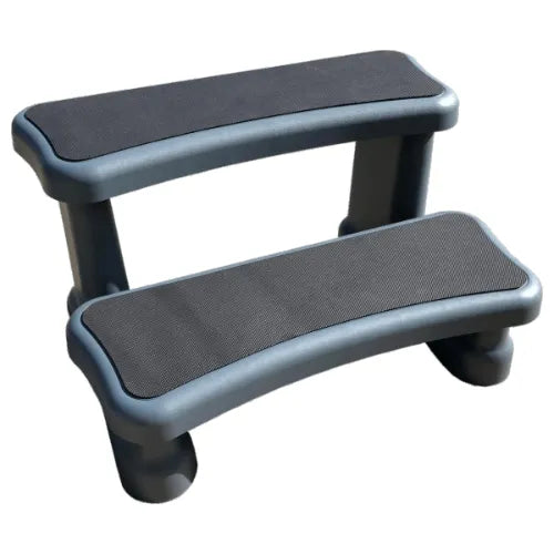 Two-step Soft Steps (Grey) from Hot Tub Liverpool with black non-slip tread surfaces on each step. The steps have rounded edges and a sturdy design, crafted with water-resistant materials to provide easy access to a hot tub or similar elevated surface.