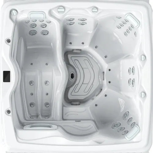 A top-down view of a square white Hot Tub Liverpool OASIS - PACIFIC - HCB560 - (32 Amp) with multiple seating areas. The tub features numerous jet placements along the sides and on the seats, designed for targeted hydrotherapy. Equipped with full foam insulation and a TP10 control system, the control panel is located on the upper left edge.