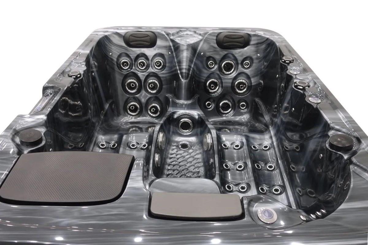 An image of a luxurious, modern compact hot tub with multiple customizable jets designed for relaxation and hydrotherapy. The Atlanta - 2-3 Person Hot Tub by Hot Tub Liverpool features seating for multiple people, headrests, and a Balboa Control System on the sides, all in a sleek, metallic finish.