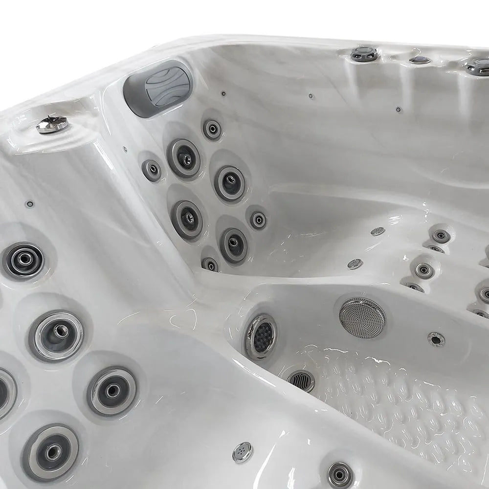 The image shows a close-up view of a white, multi-seat hot tub with customizable jets and numerous water nozzles embedded in the walls and seats. The interior appears clean and glossy, with a contoured design for comfort. The Atlanta - 2-3 Person Hot Tub from Hot Tub Liverpool also features a Balboa Control System for easy operation.