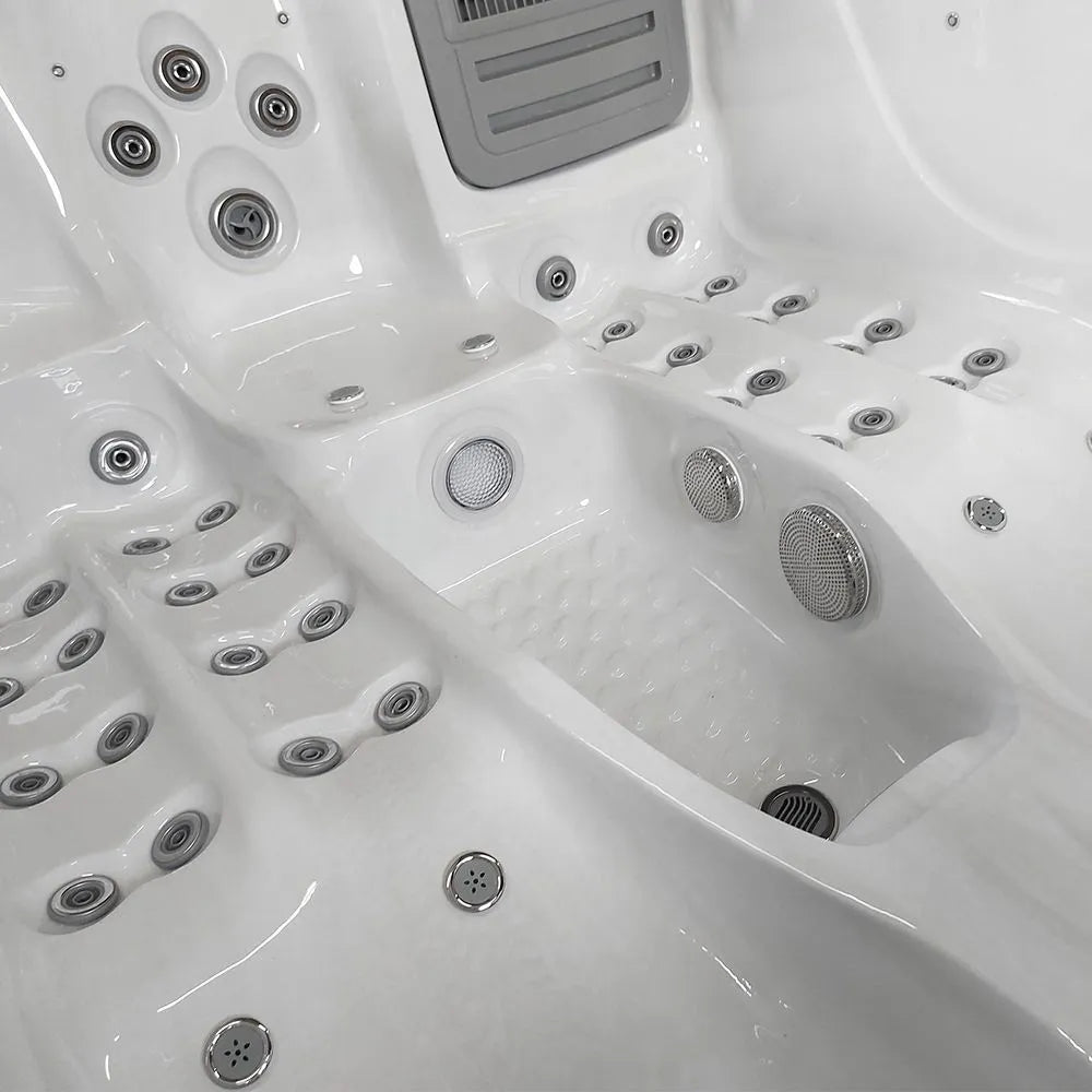A close-up view of a luxurious and spacious white Atlanta - 2-3 Person Hot Tub by Hot Tub Liverpool featuring multiple customizable jets and knobs for various settings. The interior is finely polished with ergonomic seats designed for comfort and relaxation, all seamlessly managed by the sophisticated Balboa Control System.
