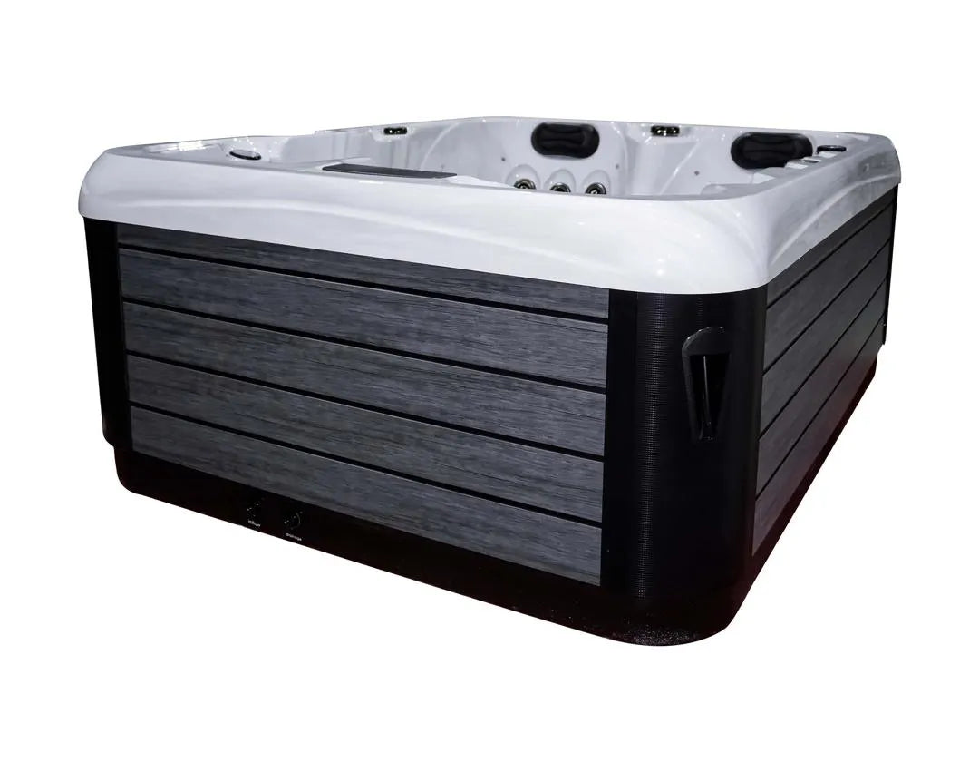 A sleek, modern compact hot tub with a white interior and dark gray wood-look exterior paneling. The Atlanta - 2-3 Person Hot Tub by Hot Tub Liverpool features several customizable jets and ergonomic seating, designed for relaxation and hydrotherapy.
