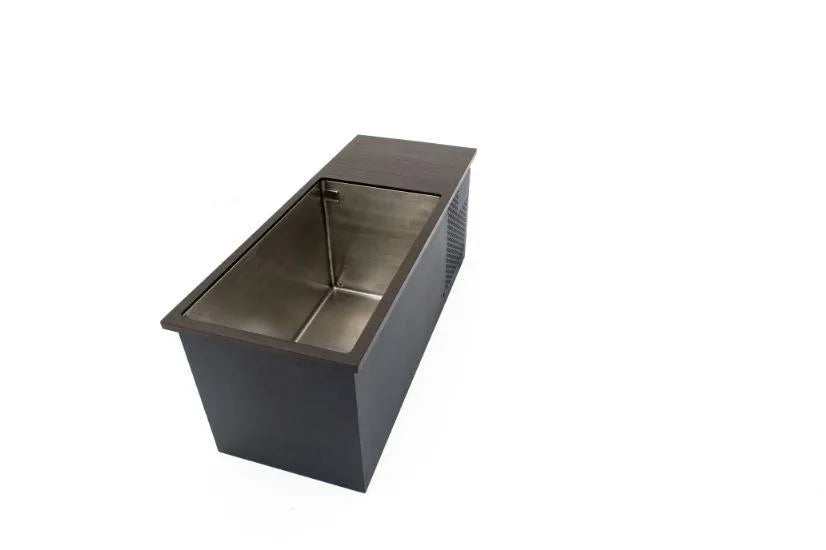 A stainless steel, rectangular sink with a dark exterior casing. The sink features a slanted front and is set against a plain white background, emphasizing its modern, minimalist design. Ideal for cold water therapy, the cover is partially slid, revealing the basin perfect for Chill Tubs - Professional affordable Ice Baths ideal for gym fanatics by Chill Tubs.