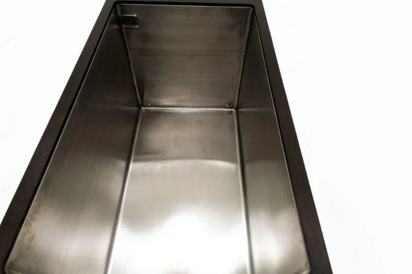 A rectangular stainless steel sink with smooth, reflective surfaces and a slightly curved bottom, ideal for cold water therapy. The Chill Tubs - Professional affordable Ice Baths ideal for gym fanatics by Chill Tubs is empty and clean, set against a plain white background, perfect for transforming into an ice tub.