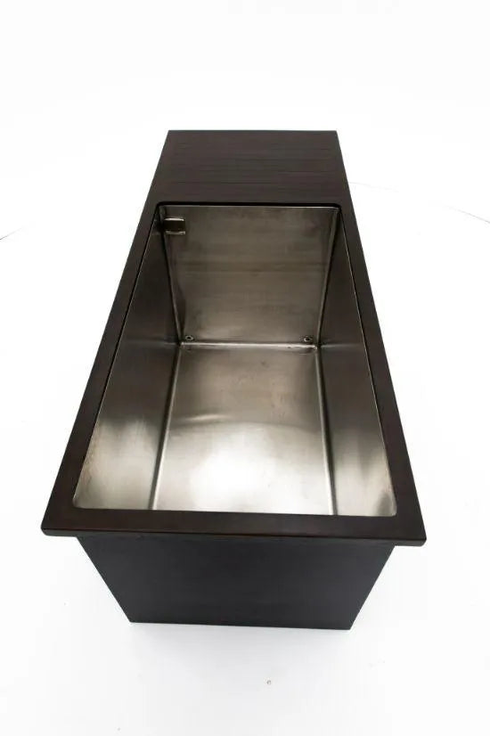 A top-down view of a rectangular stainless steel Chill Tubs - Professional affordable Ice Baths ideal for gym fanatics on a dark-colored countertop, looking perfect for cold water therapy. The Chill Tubs unit is empty and has a smooth, shiny surface, ideal for transforming into an ice tub. The background is white.