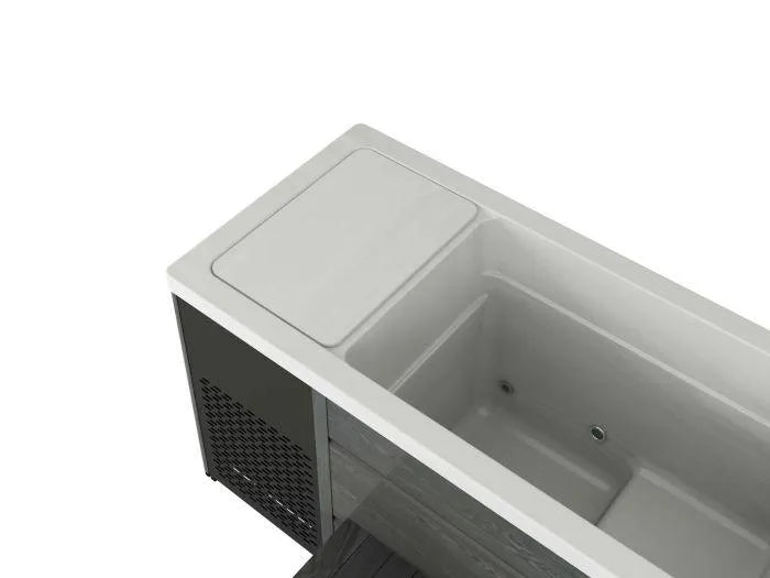 A minimalist, rectangular bathtub with a modern design. The sleek, white finish and smooth lines enhance its contemporary aesthetic, while a vented gray panel adds a unique touch. Perfect for cold water immersion, the Chillax Ice Bath & Chill Tub Professional affordable wellness Ice Baths & Plunge Pool by Chill Tubs also aids in inflammation reduction.