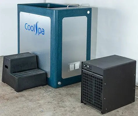 Image of a cryotherapy chamber with the brand name "Hot Tub Liverpool" written on its side. A small set of black steps leads up to the CryoHome Ice Bath Spa 1 chamber, accompanied by a separate black cooling unit on the ground. The setup features digital temperature control and is situated in a plain room.