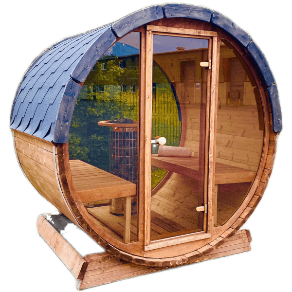 A pre-built Sunbeach Delux Moon Terrace 160 Sauna with a shingled roof and glass door is pictured. Inside, there are wooden benches and an electric Harvia heater. The sauna is elevated on a wooden base and situated outdoors, with a blurred background.