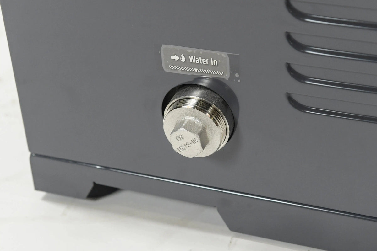 Close-up of a water inlet valve on a dark gray Hot Tub Liverpool REXENER PR200 energy efficient hot tub water heater. The valve is labeled "Water In" with an arrow indicating the direction. The surrounding area includes textured ridges and a smooth, metallic finish.