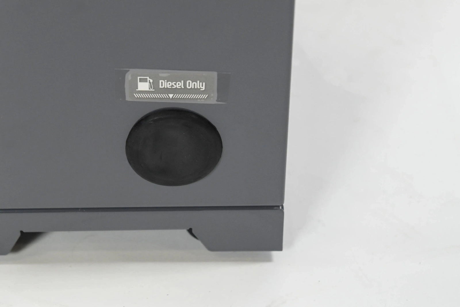 Close-up of a gray surface with a small, rectangular label that reads "Diesel Only" next to a circular, black cap. The background is plain white. Consider the REXENER PR200 energy efficient hot tub water heater from Hot Tub Liverpool for eco-friendly solutions.