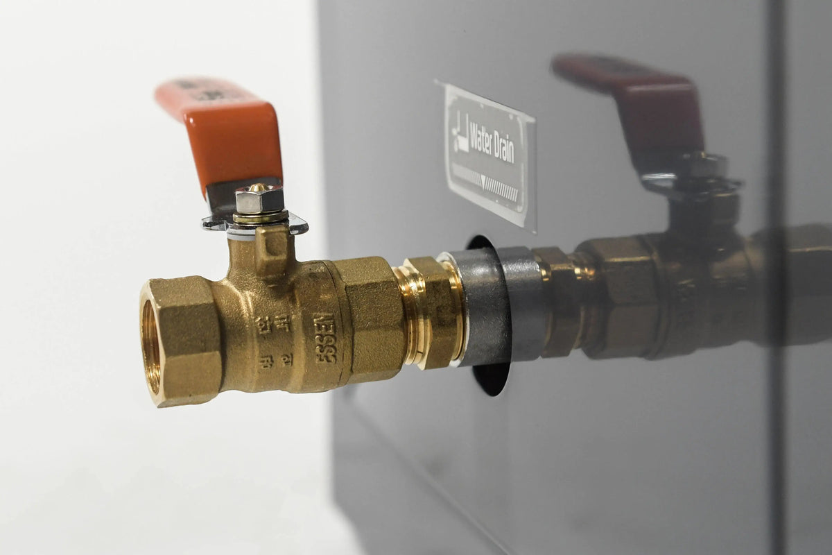 Close-up of a brass ball valve with a red handle attached to a metallic surface via a threaded connection. Common in systems like the Hot Tub Liverpool REXENER PR200 energy efficient hot tub water heater, the valve is marked with the numbers "25831" and other markings, and there is an unreadable label on the metallic surface.