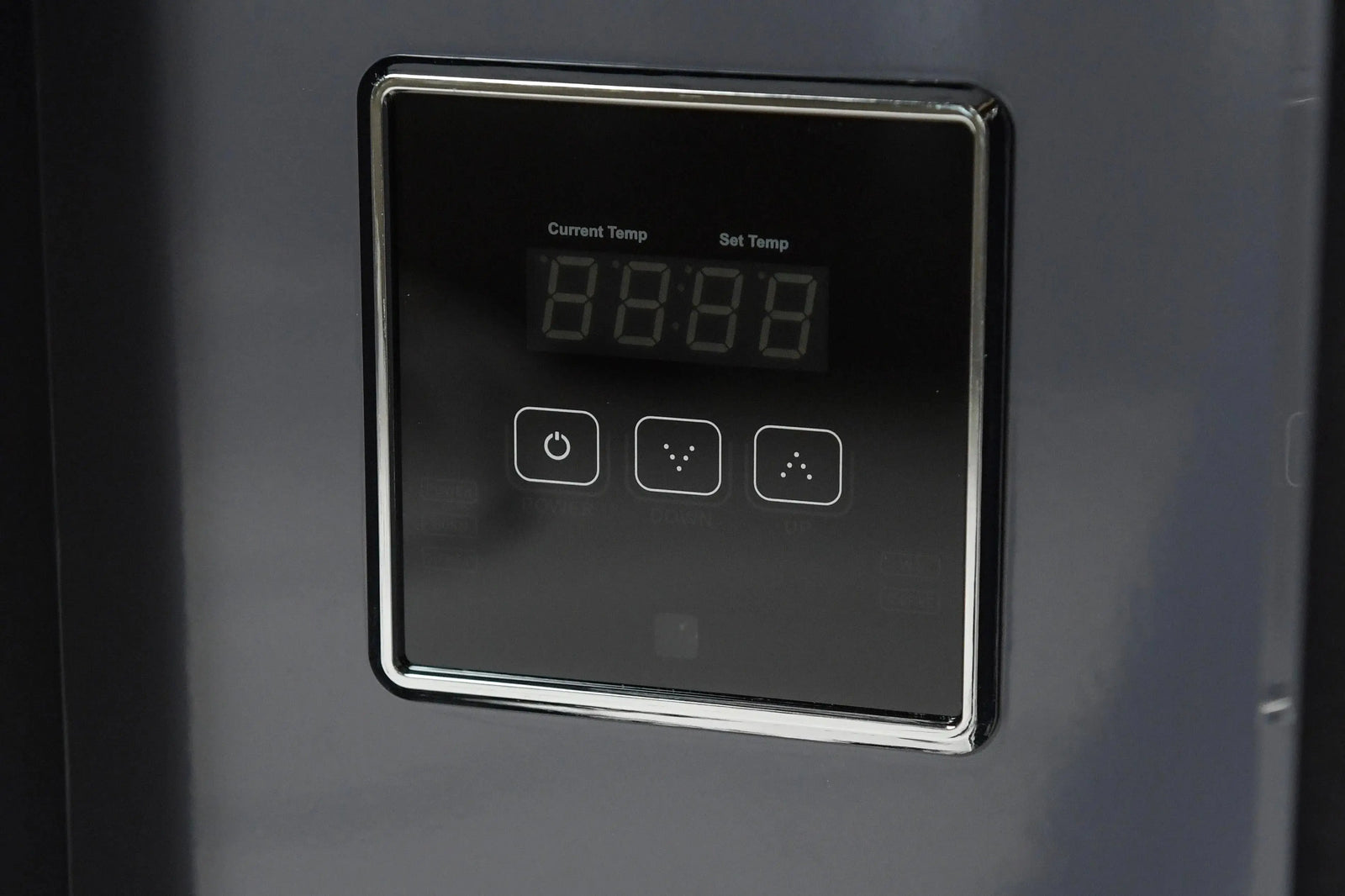 A close-up of a modern digital control panel on a Hot Tub Liverpool REXENER PR200 energy-efficient hot tub water heater, featuring a black screen with a shiny chrome border. The panel displays current temperature, set temperature, and has several touch buttons labeled with icons for power, settings, and temperature adjustment.