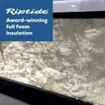 The image shows a close-up view of foam insulation inside a structure, with a blue text box in the top left corner. The text reads "Oasis Riptide - Aqua Life Hydro 4.0 Swim Spa, Award-winning full foam insulation." The foam has a white, uneven texture, filling the entire visible area. Ideal for enhancing Oasis Spas efficiency.
