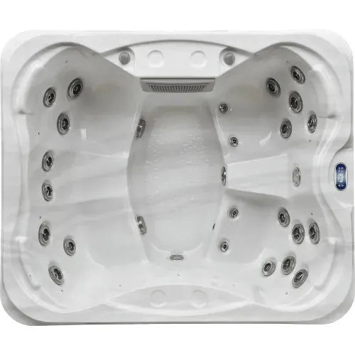 A top-down view of an empty, rectangular white Hot Tub Liverpool Sunbeach Spas - SB344S Aurora Lights - (13 Amp) with various strategically placed jets and seating contours. The tub, featuring an Aristech Acrylic Shell, has a textured surface and control buttons on the side, designed for multiple occupants.
