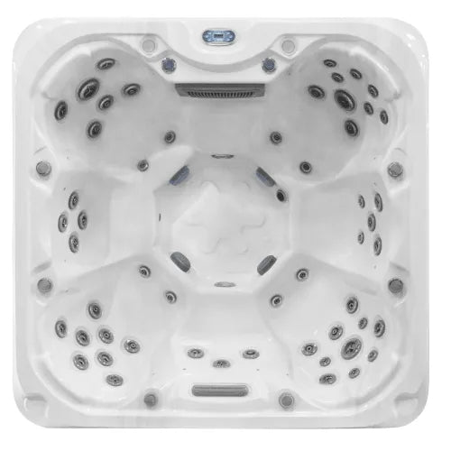 A top-down view of a white, square hot tub designed for multiple people. The Sunbeach Spas - SB377S-LUX (32Amp) by Hot Tub Liverpool features multiple jets around each contoured seat and includes a Balboa TP600 Control Panel near the top edge. It boasts a smooth, glossy USA Aristech Acrylic Shell with various fixtures and edges throughout the interior.
