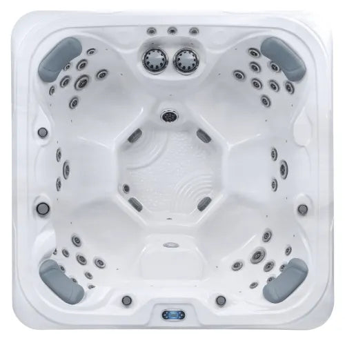 Top view of an empty, square-shaped Hot Tub Liverpool Sunbeach Spas - SB639S-Executive (32Amp) with multiple jets along its sides and bottom. The tub features a durable USA Aristech Acrylic Shell, four cushioned headrests at the corners, and a series of knobs and controls near the middle for a comfortable and relaxing experience.
