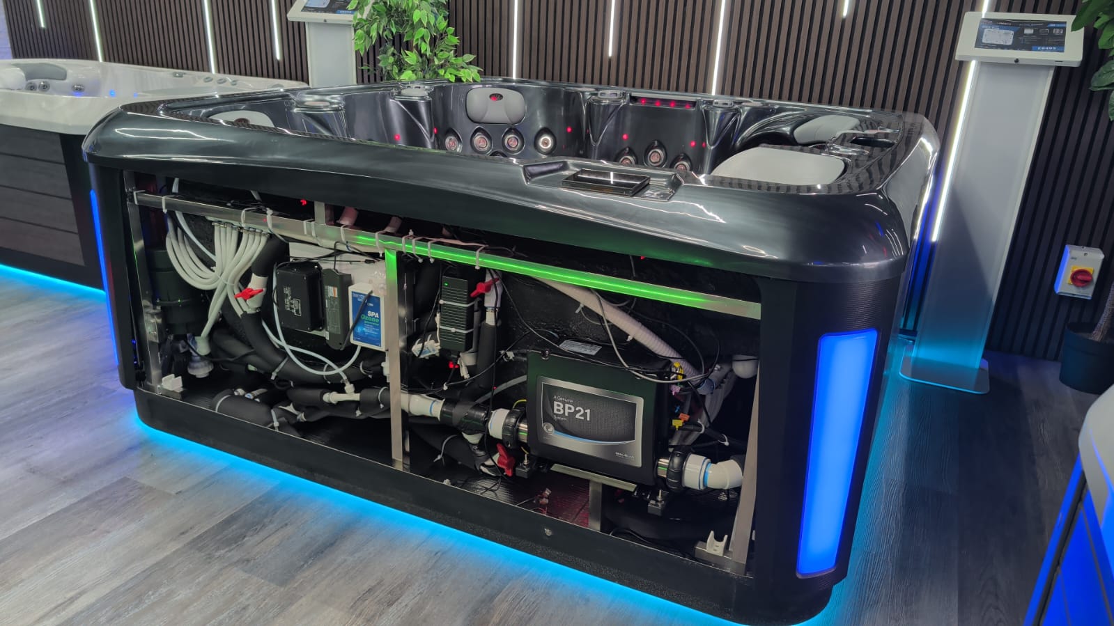 Inside Hot Tub Liverpool’s showroom, with an open cabinet showing the pipework and components